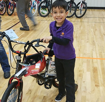 Happy Salida del Sol school boy with a new bike