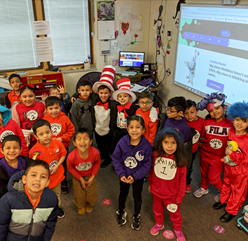 Happy elementary students dressed in Dr. Seuss themed costumes