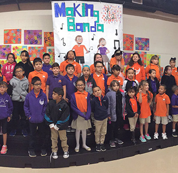 Group of happy students in front of Making Banda banner
